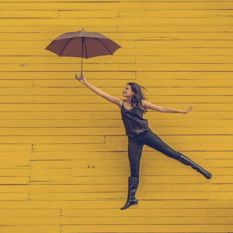woman holding brown umbrella